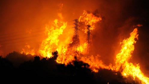 25flames cross over a ridge occupied by high voltage power lines near mountain drive and coyote road in montecito calif