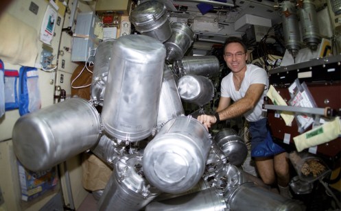 Astronaut Carl E. Walz, Expedition Four flight engineer, catalogs canisters of water in the Zvezda Service Module on the International Space Station on March 11th, 2002