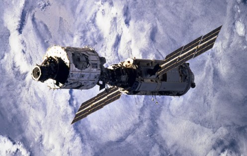 Blanketing clouds form the backdrop for this 70mm scene of the connected Zarya and Unity modules after having been released from Endeavour's cargo bay a bit earlier on December 4th, 1998