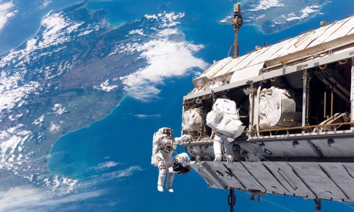 High above New Zealand and Cook Strait, astronauts Robert L. Curbeam and Christer Fuglesang work to attach a new truss segment to the ISS and begin to upgrade the power grid on December 12th, 2006