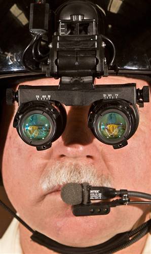 [Unrelated Imgae] Kim Harris, chief pilot for Aviation Specialties Unlimited, Inc., looks through night vision goggles inside the hangar at his company's headquarters in Boise, Idaho. Because of wars in Iraq and Afghanistan, there is a shortage of goggles available to American medical pilots.