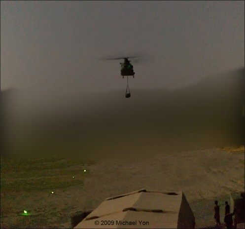 A CH-47 helicopter whirls in with a “sling load” of resupplies from Camp Bastion to FOB Jackson in Sangin