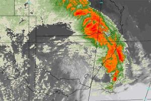 An enhanced colour satellite image shows the dust storm covering eastern Australia earlier today.