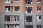 A couple check their belongings in their apartment after a blast destroyed all the windows. (Fred&nbsp;Dufour)