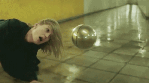 A Floating Orb Menaces Rosamund Pike